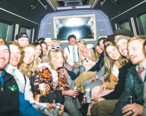 A group of people in a party bus on their wedding day